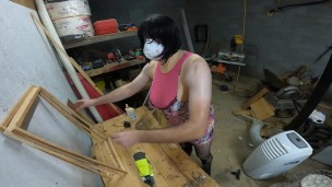 Big fake tits crossdresser in pink drees fishnets and heels doing wood work