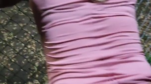 Sissy dildoing her ass in a public park gets help from a man to use the pink dildo in her