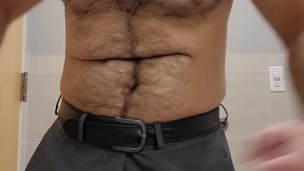 Muscle bear strips off dress pants to show off cock