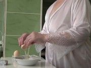 Mature MILF housewife with big natural tits is in the kitchen cooking scrambled eggs. 1/16