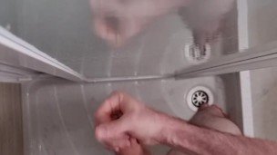 Guy jerks off and cums a big load in the shower