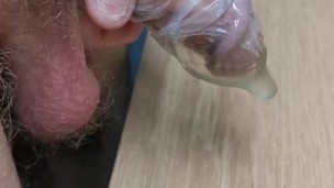 Filling a condom with piss and playing with it