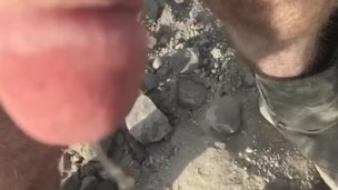 Slow motion piss too put out the campfire in the desert