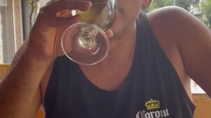 Pissing in a glass and drinking in public in a street restaurant