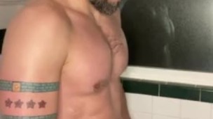 Bearded jock rubs piss all over chest
