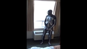 skeleton jerking off at hotel window watching truck drivers get ready for work