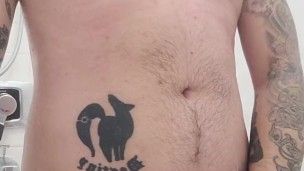 Tattooed guy cums a load in the shower