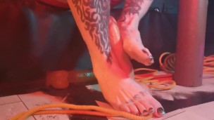 Rubbing a rubber cock with my tattooed hands and feet
