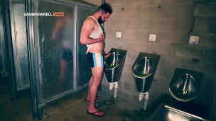 Furry muscle hunk shows off his big thick cock at the public urinal