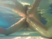 Elegant and flexible babe, swimming underwater in the outdoor swimming pool. 3 1 15/16
