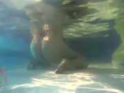 Elegant and flexible babe, swimming underwater in the outdoor swimming pool. 3 1