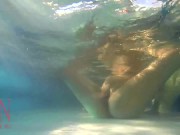 Elegant and flexible babe, swimming underwater in the outdoor swimming pool. 3 2 1/16