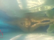 Elegant and flexible babe, swimming underwater in the outdoor swimming pool. 3 2 12/16