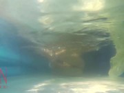 Elegant and flexible babe, swimming underwater in the outdoor swimming pool. 3 2 13/16