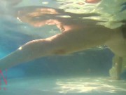 Elegant and flexible babe, swimming underwater in the outdoor swimming pool. 3 2 5/16