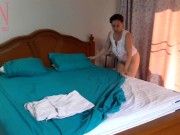 Nudist housekeeper Regina Noir makes the bedding in the bedroom. Naked maid. Naked housewife. c1 15/16