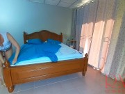 Nudist housekeeper Regina Noir makes the bedding in the bedroom. Naked maid. Naked housewife. c2 13/16