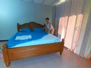 Nudist housekeeper Regina Noir makes the bedding in the bedroom. Naked maid. Naked housewife. c2 15/16