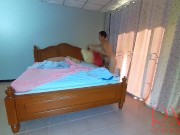Nudist housekeeper Regina Noir makes the bedding in the bedroom. Naked maid. Naked housewife. c2 3/16