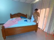 Nudist housekeeper Regina Noir makes the bedding in the bedroom. Naked maid. Naked housewife. c2 5/16