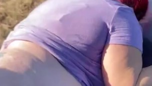 Bent over the hood of my car in a field