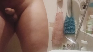 Young fat guy takes a shower and massages his dick with a shower