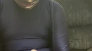Jacking off condomed dildo with lotion in full blue spandex suit