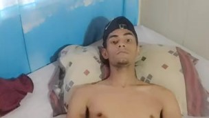 cute boy playing with his feet and dick