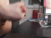 Jerking off a load into a glass mug