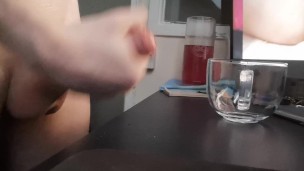 Jerking off a load into a glass mug