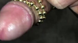 Watch me use a beaded necklace to stimulate my cock while I masturbate and cum