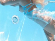 Her body cutting through the shimmering water of the pool 2/16