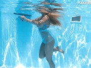 Her body cutting through the shimmering water of the pool 4/16