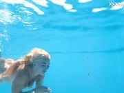 Her body cutting through the shimmering water of the pool 8/16