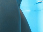 Her body cutting through the shimmering water of the pool 9/16