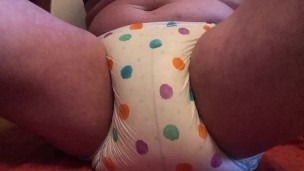 Diaper full of pee and sitting on the floor to feel and ejoy whole wetness