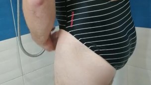 Boy wearing Speedo one piece swimsuit and jerking