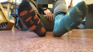 Twink boy feet in different colored socks in school