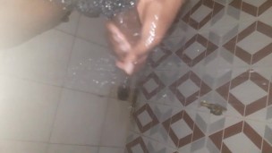 African teen mastrubating in the shower with his big cock
