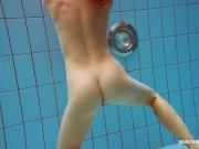 In the indoor pool, a stunning girl swims 11/16