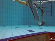 In the indoor pool, a stunning girl swims 6/16