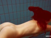 In the indoor pool, a stunning girl swims 7/16