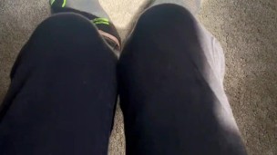 Two socked feet rub against one another - SFW