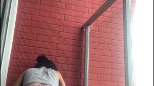 Lesbians have public sex on the balcony of the apartment.