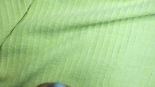 Painted nails on a green sheet