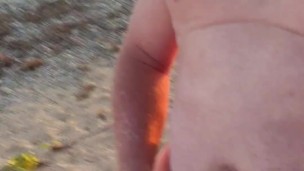Naked on the beach wanking and cuming on the rock