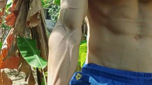 Muscular guy jerks off in the banana plantation
