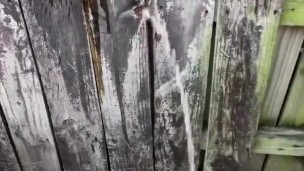 Boner peeing while jerking off on a fence outside