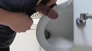 Risky wank in public urinal at work. Man's room