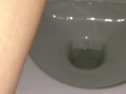 Girl pissing in public toilet with tampon inside. Very hairy pussy